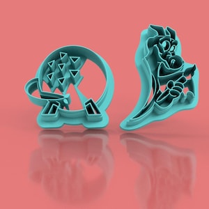 May include: Two turquoise plastic cookie cutters on a coral background. One cutter is a circular shape with triangular cutouts. The other cutter is a cartoon character with a long, flowing shape. The cutters are likely for making cookies or other baked goods.