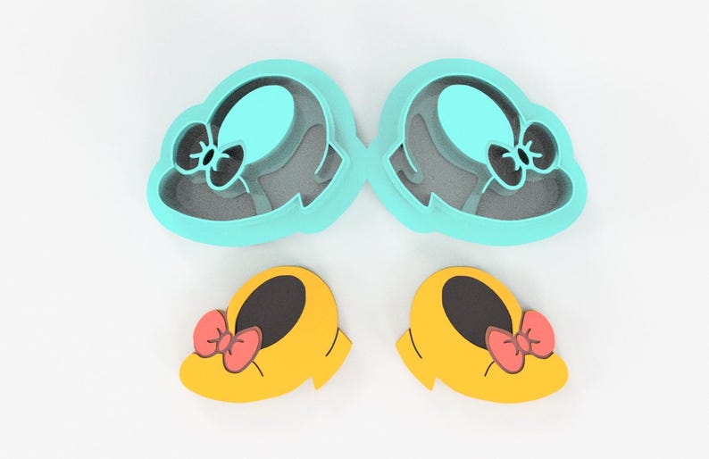 May include: A set of four cookie cutters in a whimsical design. Two are shaped like hats with bows, and two are shaped like yellow shoes with red bows. The cutters are made of plastic and are on a white background.
