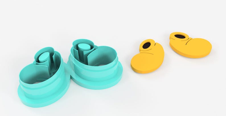 May include: A set of turquoise cookie cutters and two yellow cookie cutters shaped like cartoon character shoes. The cookie cutters are made of plastic and are on a white background.