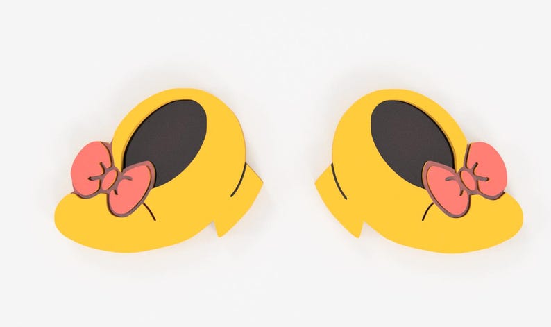 May include: Two yellow shoe-shaped decorations with black interiors and coral-colored bows. The shoes have a rounded shape with a small heel and are set against a white background. The bows have a dark pink outline.