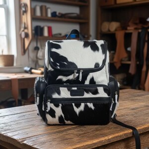 cowhide backpack

hair on hide bag

leather rucksack

cowhide purse

travel backpack

Christmas gift mom

leather gym bag

mom gift idea

cowhide leather bag

weekend travel bag

handmade leather bag

carry on backpack

boho cowhide bag