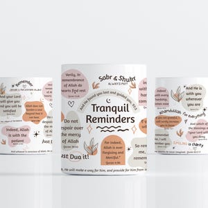 May include: Three white ceramic mugs with inspirational quotes and floral designs. The mugs feature phrases like "Tranquil Reminders" and "Smiling is charity" in a mix of fonts and colors.