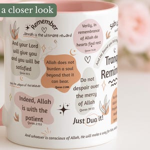 May include: White ceramic mug with a pink handle and rim, decorated with inspirational quotes and floral accents. The mug features phrases like "Indeed, Allah is with the patient" and "Just Dua it!"