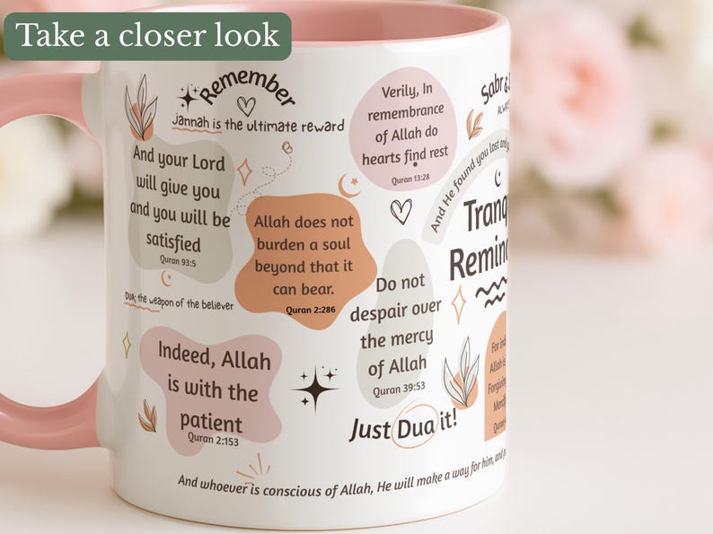 May include: White ceramic mug with a pink handle and rim, decorated with inspirational quotes and floral accents. The mug features phrases like "Indeed, Allah is with the patient" and "Just Dua it!"