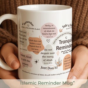 May include: White ceramic mug with a curved handle, featuring Islamic reminders in various fonts and colors. The mug includes phrases like "Tranquil Reminders" and "Just Dua it!" with decorative elements.