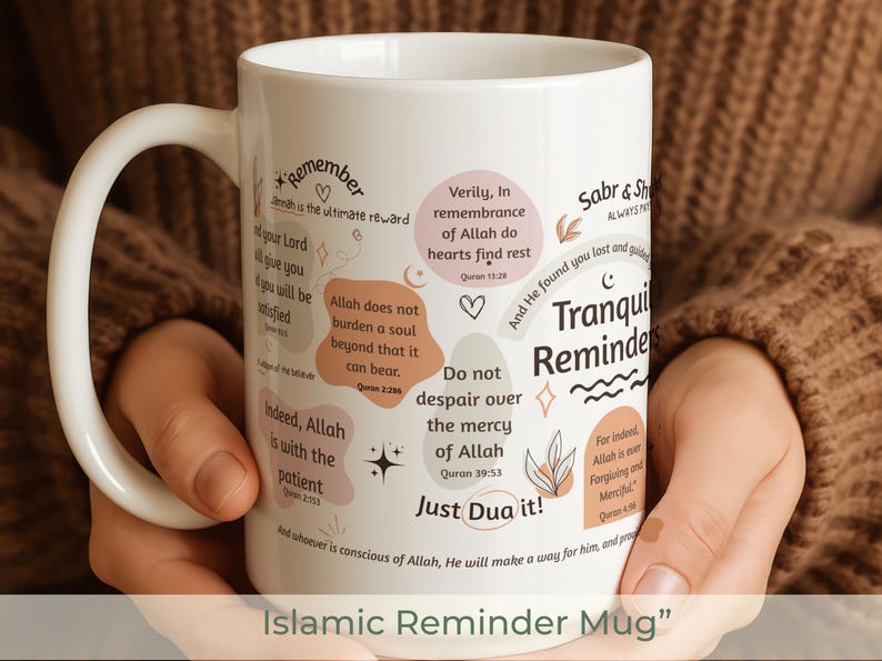 May include: White ceramic mug with a curved handle, featuring Islamic reminders in various fonts and colors. The mug includes phrases like "Tranquil Reminders" and "Just Dua it!" with decorative elements.