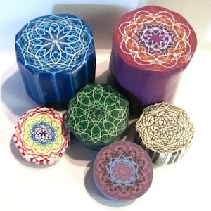 May include: Six colourful round and hexagonal polymer clay ornaments with intricate geometric designs. Each ornament features a different colour and pattern, including blue, green, purple, red, white and black.