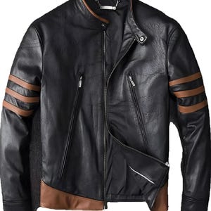 May include: Black leather jacket with brown accents. Features include a stand-up collar, a zipper closure, and brown stripes on the sleeves. The jacket has two zippered pockets and brown panels at the bottom. A stylish outerwear piece.