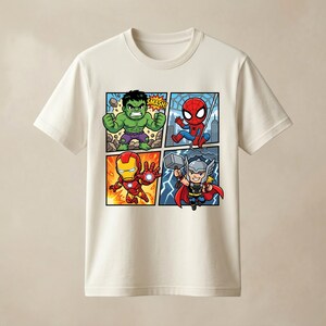 May include: A cream-coloured short-sleeve t-shirt featuring a four-panel graphic print of cartoon superheroes. The design includes the Hulk with the text SMASH, Spider-Man, Iron Man, and Thor holding a hammer, all rendered in vibrant colours.