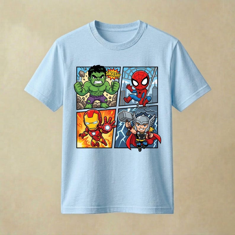 May include: A light blue short-sleeved t-shirt featuring a four-panel comic book graphic on the front. The print displays cartoon versions of Hulk with the text SMASH, Spider-Man, Iron Man, and Thor holding a hammer against a lightning background.