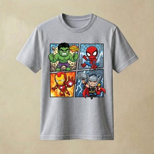 May include: A heather grey short-sleeved t-shirt featuring a four-panel comic book graphic. The print displays chibi-style illustrations of the Hulk with the text SMASH, Spider-Man, Iron Man, and Thor holding a hammer against a lightning background.
