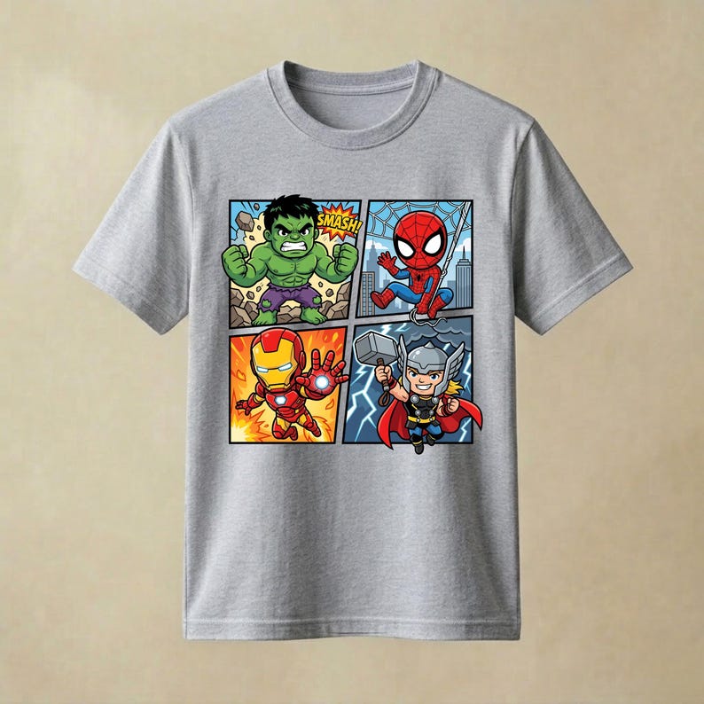 May include: A heather grey short-sleeved t-shirt featuring a four-panel comic book graphic. The print displays chibi-style illustrations of the Hulk with the text SMASH, Spider-Man, Iron Man, and Thor holding a hammer against a lightning background.