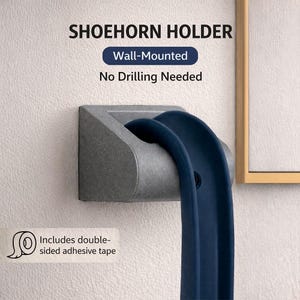 May include: A grey wall-mounted shoehorn holder with a navy blue shoehorn. The image text reads "SHOEHORN HOLDER", "Wall-Mounted", "No Drilling Needed", and "Includes double-sided adhesive tape".