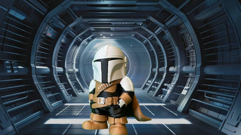Handmade Mandalorian-inspired chibi figure displayed in front of a desert dome building, perfect for Star Wars collectors seeking a unique, adorable display piece.