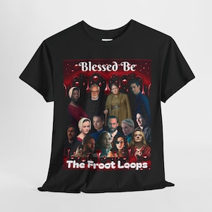 May include: Black t-shirt featuring a group of people with the text "Blessed Be" and "The Froot Loops" in red and white. The design is a parody of a popular TV show. The shirt is made of a soft material.