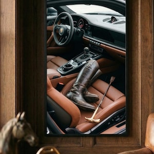 Puede incluir: Imagen enmarcada de un interior de coche de lujo con asientos de cuero marr&oacute;n y un volante. Un par de botas de montar marrones y una fusta con mango dorado descansan en el asiento.