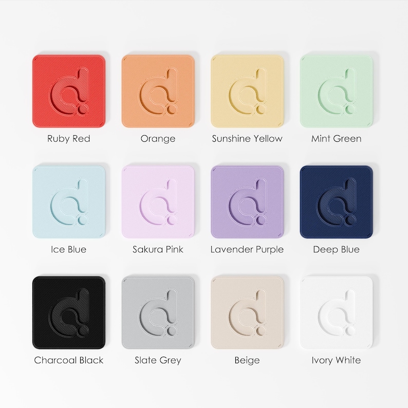 a collection of twelve square icons, each representing a different color. The icons are arranged in a grid of three rows and four columns. Each icon is labeled with a different color, including Ruby Red, Orange, Sunshine Yellow, Mint Green, Ice Blue, Sakura Pink, Lavender Purple, Deep Blue, Charcoal Black, Slate Grey, Beige, and Ivory White.