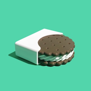 May include: A chocolate sandwich cookie with a white filling, partially inside a white cardboard container. The cookie is on a mint green background.