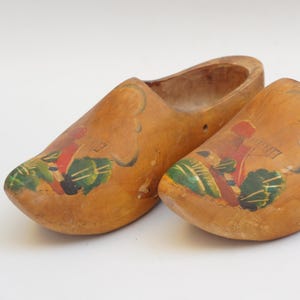 May include: A set of three ceramic mugs with a speckled, matte finish. The mugs are in shades of cream, light brown, and dark brown. Each mug has a simple, minimalist design, perfect for coffee or tea.