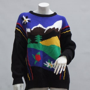 May include: A black, blue, green, white, and yellow knit sweater with a mountain scene and flowers.