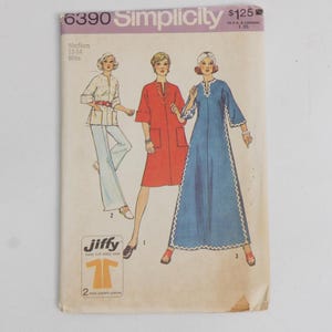 May include: A Simplicity 6390 sewing pattern envelope featuring illustrations of three outfits: a white tunic with pants, a red knee-length dress, and a long blue dress with white trim. The text includes the brand name Simplicity, pattern number 6390, and Jiffy.