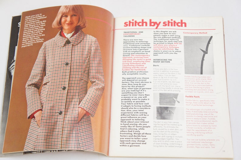 May include: A close-up of a magazine page with a woman wearing a red and white checkered coat. The text on the page reads "stitch by stitch" and discusses traditional and contemporary tailoring methods.
