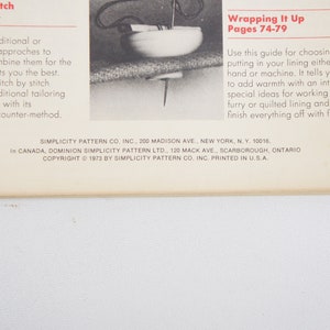 May include: A page from a sewing pattern book with instructions for stitching and wrapping up a coat. The text includes the titles "Stitch by Stitch" and "Wrapping It Up" with corresponding page numbers. The copyright information at the bottom of the page reads "Copyright 1973 by Simplicity Pattern Co. Inc. Printed in U.S.A."