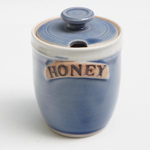 May include: A set of three ceramic mugs with a speckled, matte finish. The mugs are in shades of cream, light gray, and dark gray. Each mug has a simple, minimalist design, perfect for coffee or tea.