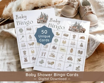 May include: Two white paper Baby Bingo game cards featuring woodland animal illustrations and a grid of baby-related icons. A blue hexagonal overlay in the center displays the text 50 Unique Cards. The cards are placed on a soft fabric surface.