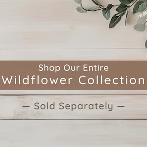 A promotional banner with the text "Shop Our Entire Wildflower Collection — Sold Separately" set against a light wood background with green eucalyptus leaves.