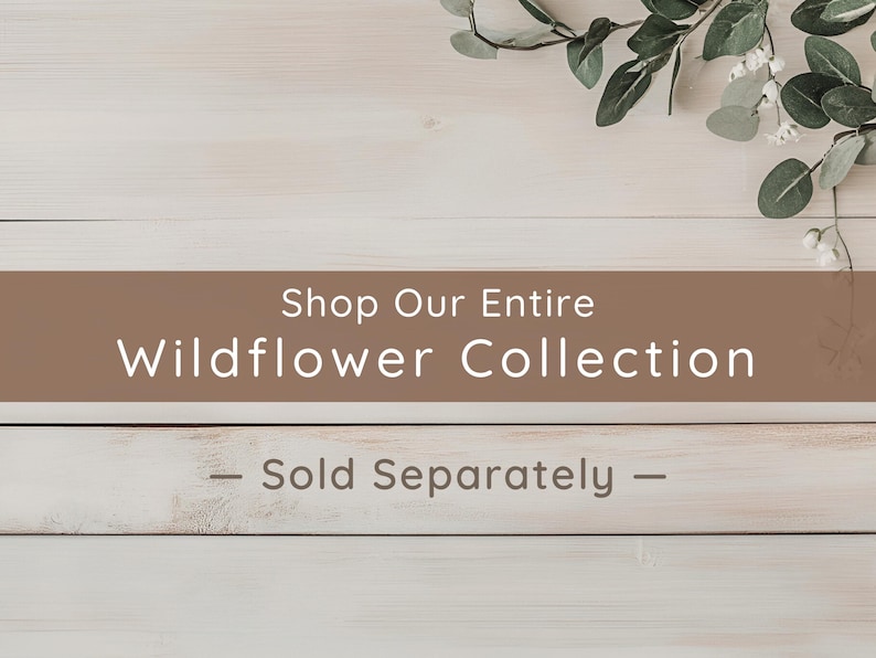 A promotional banner with the text "Shop Our Entire Wildflower Collection — Sold Separately" set against a light wood background with green eucalyptus leaves.