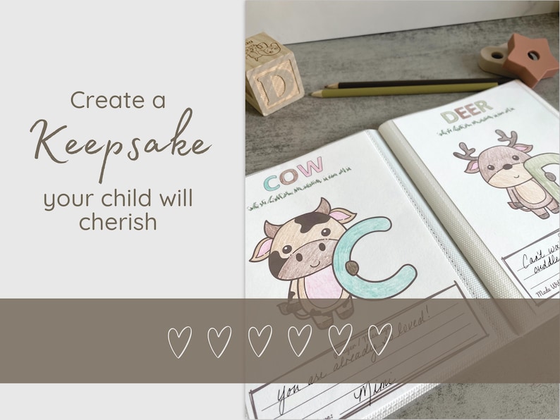 May include: A personalized keepsake book with the text "Create a Keepsake your child will cherish." The book features illustrations of a cow and a deer, with the letters "C" and "D" in a colorful design. A wooden block and pencils are also visible.
