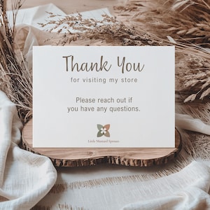 A white card with the words "Thank You" in a handwritten style font. The text "for visiting my store" and "Please contact me if you have any questions" are also present. The card includes a floral logo and the words "Little Mustard Sprouts".