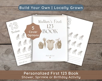 Puede incluir: Un libro personalizado 123 con una portada central que muestra el texto Walker's First 123 BOOK, un body de bebé y cestas de productos. Una insignia marrón indica 5 Cover Options. Dos páginas laterales muestran el número 13 y maíz.