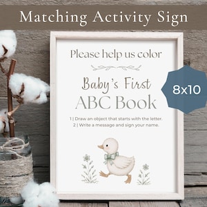 May include: A rectangular sign in a light wood frame featuring the text Please help us color Baby's First ABC Book, instructions, and a small illustration of a duckling. A blue badge on the sign displays the text 8x10 inches.