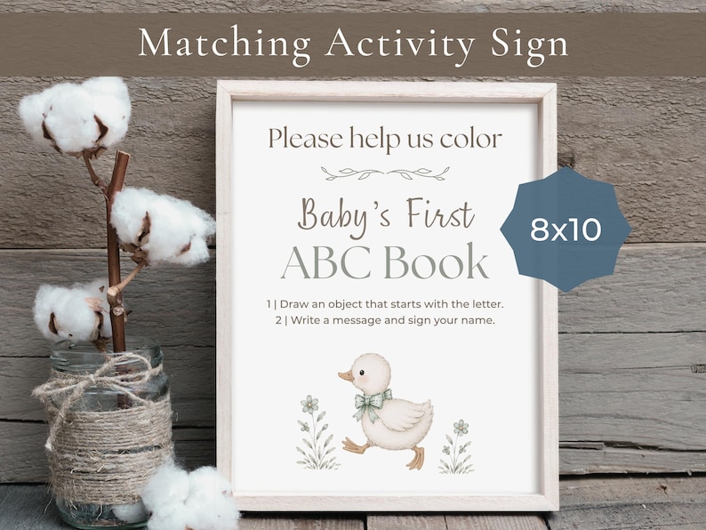 May include: A rectangular sign in a light wood frame featuring the text Please help us color Baby's First ABC Book, instructions, and a small illustration of a duckling. A blue badge on the sign displays the text 8x10 inches.