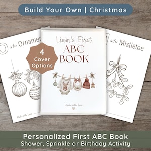 May include: A personalized ABC book for children with a white cover featuring a clothesline illustration with a baby bodysuit, bib, and hat. The text reads Liam's First ABC BOOK and Made with Love. Two additional pages show O is for Ornament and M is for Mistletoe.