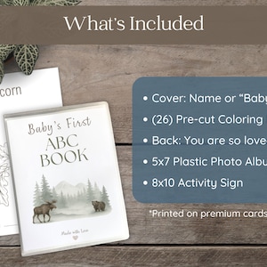 Moose and mountain-themed woodland baby shower ABC book, physical guest book alternative with warm hand-drawn sketch illustrations, 26 A–Z coloring pages for guests to sign, creating a treasured keepsake for baby.