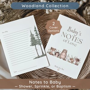 May include: Two baby shower or baptism themed notebooks. One notebook has lined pages with a watercolor illustration of two pine trees. The other notebook has the text "Baby's Notes of Love" and woodland animal illustrations.
