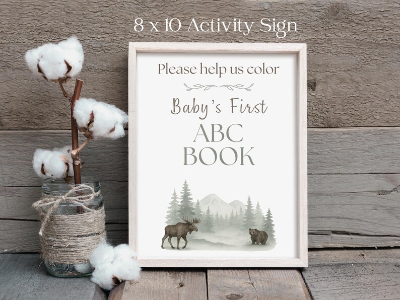 Rustic woodland ABC coloring book guest book alternative for baby shower, physical book with moose and mountain sketch illustrations, 26 A–Z pages for guests to color and sign, creating a heartfelt baby keepsake.