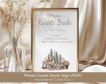 May include: A rectangular gold-framed sign with white background featuring the text Photo Guest Book, instructions to snap, stick, and sign, and a watercolor illustration of a fox, deer, bear, and hedgehog in a forest setting.
