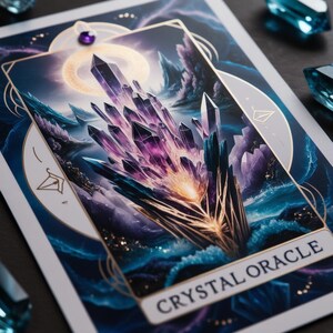 May include: A purple and gold crystal oracle card with a large crystal formation in the center. The card has a dark blue background with a gold border and the text "CRYSTAL ORACLE" at the bottom.