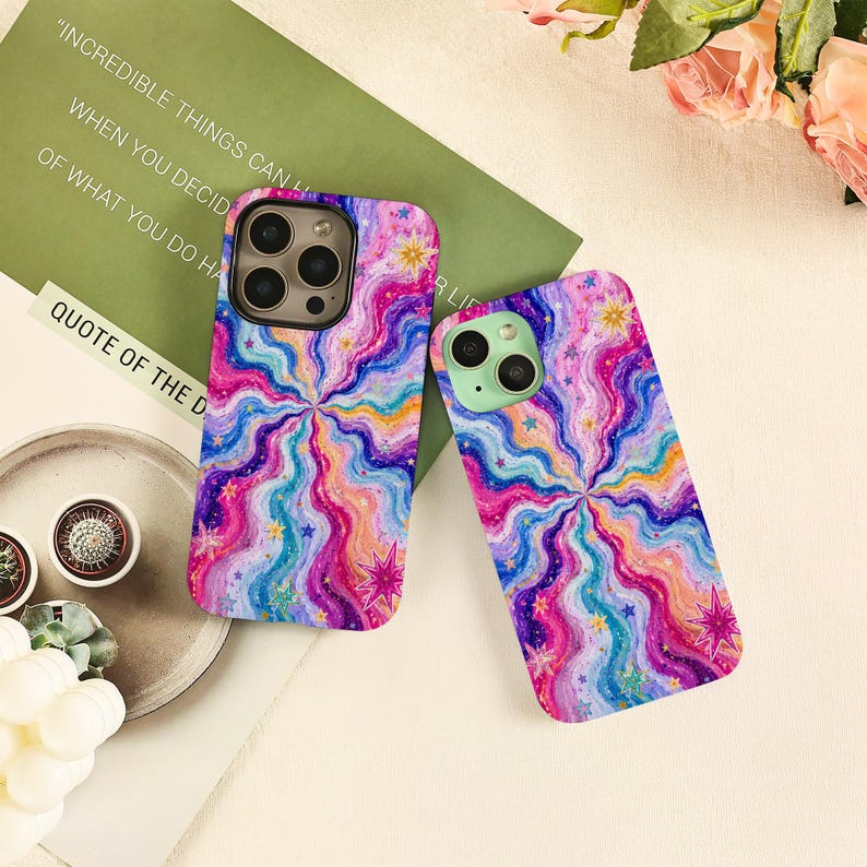 May include: Two smartphone cases featuring a vibrant, multi-colored wavy pattern in shades of pink, blue, purple, and orange. The design includes scattered small star shapes and larger, multi-pointed star icons throughout the swirling, psychedelic-inspired graphic print.