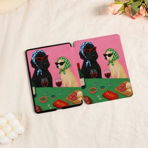Pu&ograve; includere: Custodia per tablet con una divertente illustrazione di due cani con occhiali da sole e foulard, che si godono vino e snack. Lo sfondo &egrave; rosa, con la parola "SASSY" su un piccolo cartello rosso.