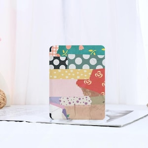 May include: A colorful patterned book cover with a patchwork design featuring various colors, polka dots, and floral patterns.
