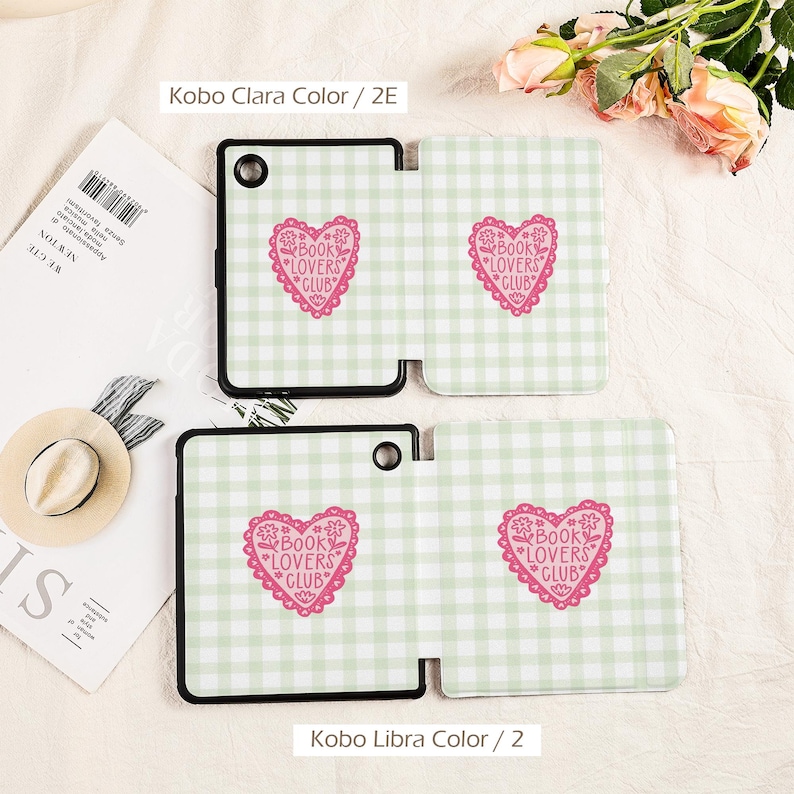 May include: Two e-reader covers with a light green and white gingham pattern. Each cover features a pink heart with the text "BOOK LOVERS CLUB". The covers are black and white and are labeled "Kobo Clara Color / 2E" and "Kobo Libra Color / 2".