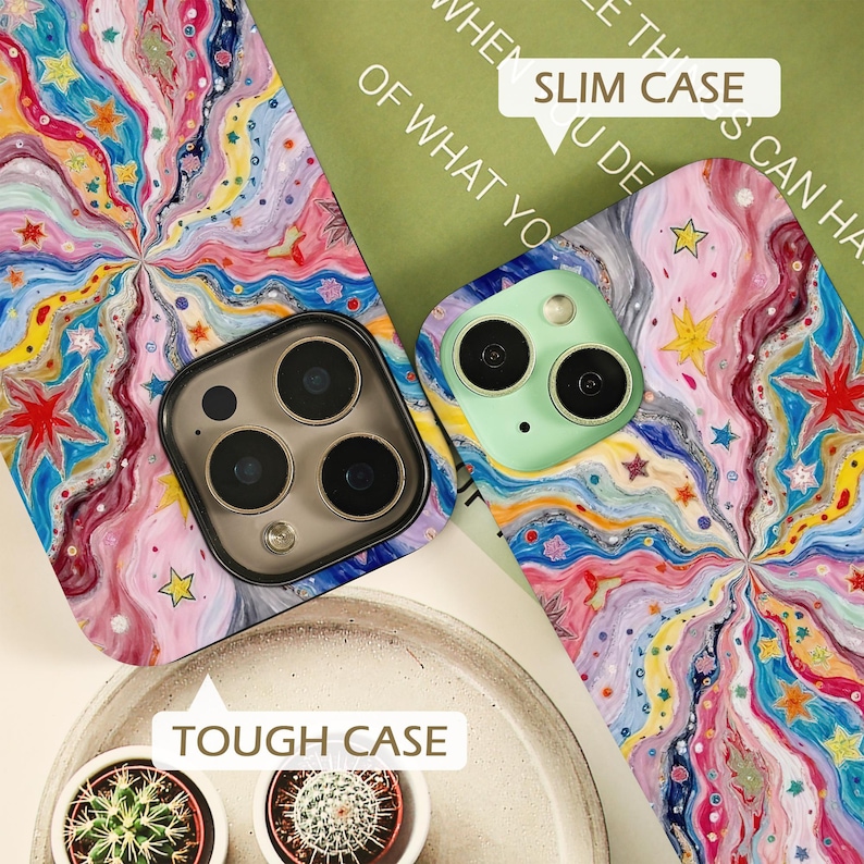 May include: Two phone cases featuring a vibrant, swirling pattern of pink, blue, yellow, and white waves decorated with small colorful stars. One case is labeled as a Slim Case, while the other is identified as a Tough Case, each with camera cutouts.