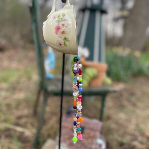 May include: A set of three ceramic mugs with a speckled, matte finish. The mugs are in shades of cream, light gray, and dark gray. Each mug has a simple, minimalist design, perfect for coffee or tea.