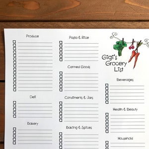 May include: A white grocery list labelled "Gigi's Grocery List" with sections for produce, pasta, canned goods, deli, condiments, bakery, baking, beverages, health, and household items. The list has check boxes and a broccoli and carrot illustration.