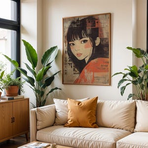 May include: A white sofa with a brown cushion in a living room featuring a framed print of a woman's face with black hair and a red shirt. The print is on a white wall with a large window behind the sofa. There are plants in the room.